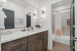 Full bathroom with shower / bathtub combination with curtain, vanity, and tile floors