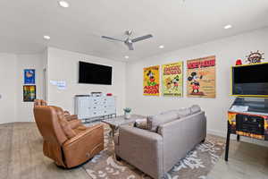 Living room with a ceiling fan, light tile floors, and recessed lighting