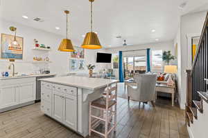 Kitchen with light cabinets, tile floors, tasteful backsplash, pendant lighting, and recessed lighting