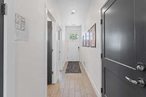 Corridor featuring light wood-style flooring and recessed lighting