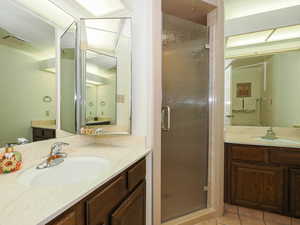 Master Bathroom featuring a new  shower stall and two vanities.