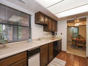 Kitchen has view of the deck and yard.  Kitchen has a pantry for storage.