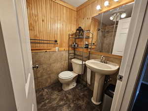 Full bath with tile walls and a tile shower