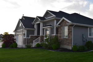 View of front of property featuring stone and stucco siding, board and batten siding