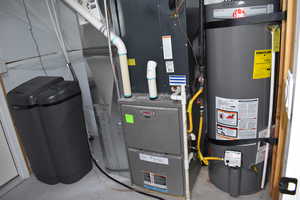 Utility room featuring strapped water heater , furnace and water softener