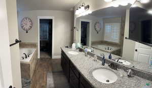 Bathroom with a bath, double vanity, and granite countertops. Separate Garden Tub and Walk In (Roman Style) shower