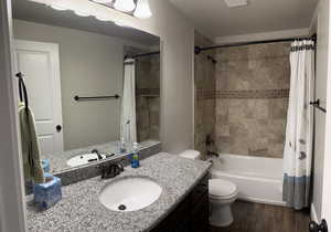 Full Bathroom with tiled tub surround, cast iron tub and granite countertops