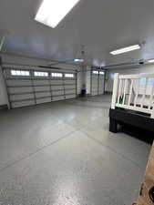 View of 4 car garage. Motion sensor lights installed