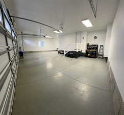 View of 4 car garage. Motion sensor lights installed