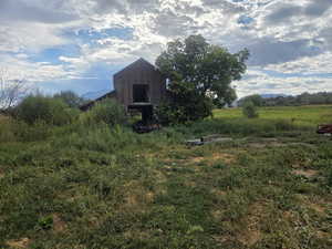 View of yard with a mountain view, an outbuilding, and a barn