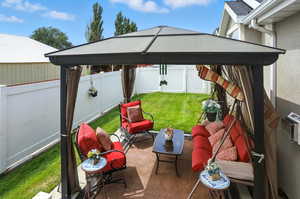 Fenced backyard with a gazebo and a patio area