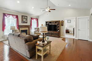 Living area featuring dark wood finished floors, a fireplace, healthy amount of natural light, recessed lighting, and ceiling fan