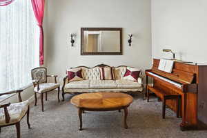 Living area with carpet floors and baseboards