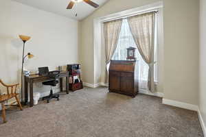 Office featuring healthy amount of natural light, light carpet, lofted ceiling, and a ceiling fan