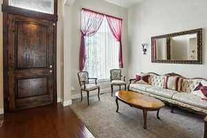 Sitting room with dark wood-style floors and baseboards