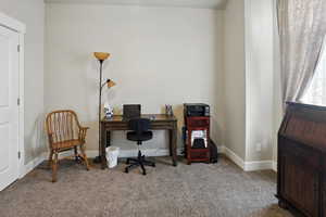 Carpeted home office with baseboards