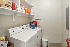 Washroom featuring separate washer and dryer and electric panel