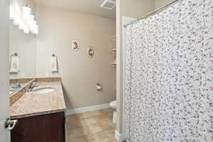 Bathroom featuring vanity, a stall shower, and light tile patterned floors