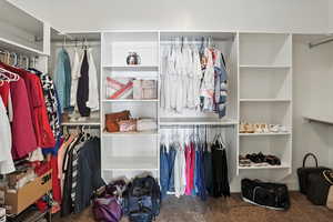 Walk in closet with carpet flooring