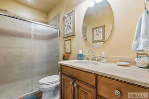 Bathroom featuring vanity and a shower stall