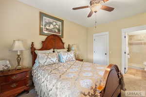 Bedroom featuring a closet, ceiling fan, and carpet flooring