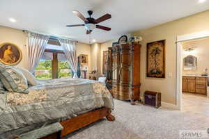 Bedroom featuring light carpet, ensuite bathroom, access to outside, ceiling fan, and recessed lighting