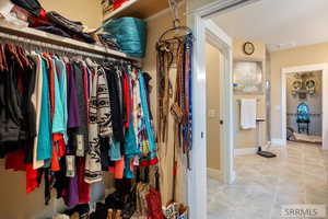Spacious closet with light tile patterned floors