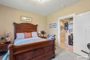 Bedroom featuring baseboards and light colored carpet