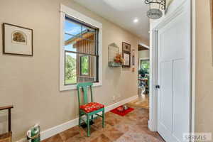 Hall featuring baseboards and a textured wall