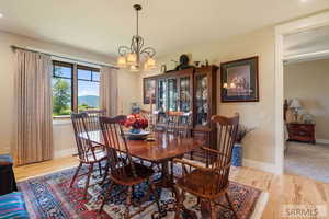 Dining room featuring light wood-style floors and a chandelier