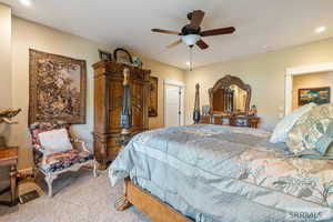 Carpeted bedroom featuring a ceiling fan and recessed lighting