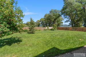 Fenced backyard with a mountain view