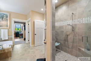 Full bath with a shower stall, a garden tub, recessed lighting, and light tile patterned flooring