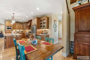 Dining area featuring light wood-style floors and recessed lighting