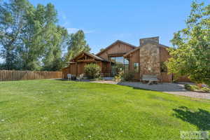 Back of property featuring stone siding