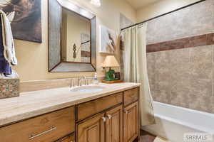 Bathroom with shower / tub combo and vanity
