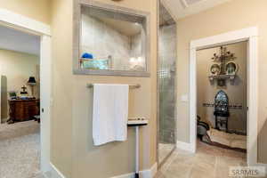 Full bathroom featuring a shower stall and light tile patterned floors
