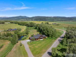 Aerial overview of property's location featuring rural landscape and a water and mountain view