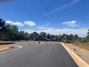 View of asphalt road featuring curbs