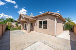 Rear view of property featuring a fenced backyard, a patio area, and stucco siding