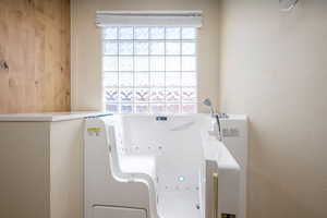 Washroom featuring washer / dryer