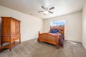 Bedroom featuring carpet and ceiling fan