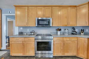 Kitchen featuring induction range and maple cabinets