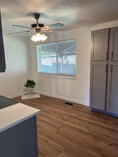 Unfurnished dining area with dark wood finished floors and a ceiling fan