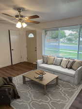 Living room with wood finished floors and ceiling fan
