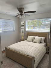 2nd Bedroom featuring wood finished floors, multiple windows, and a ceiling fan