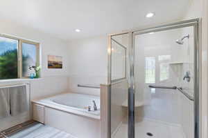 Full bathroom with a stall shower, a whirlpool tub, recessed lighting, and wood finished floors