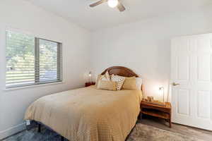 Bedroom with ceiling fan and wood finished floors