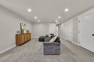Living room with recessed lighting and light carpet