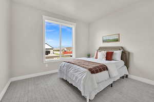 Carpeted bedroom featuring baseboards